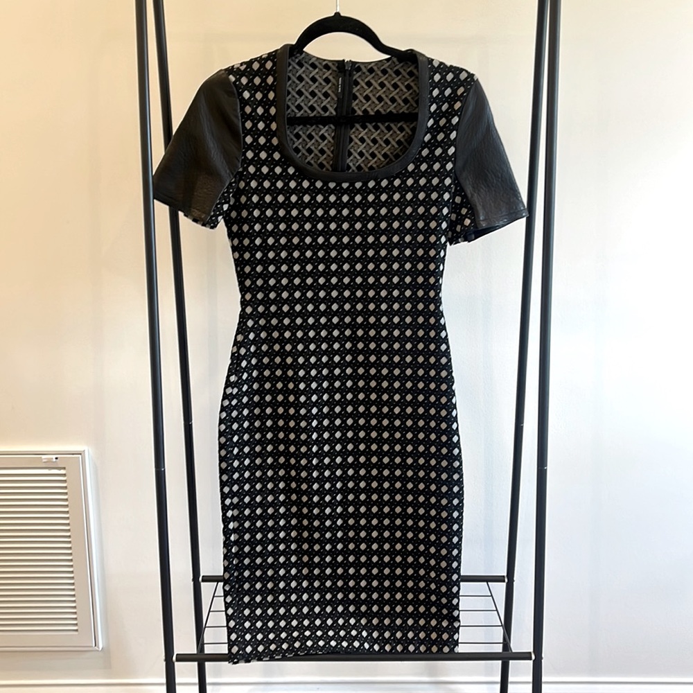 Beautiful stretchy dress with leather sleeves, size 6. Never worn.